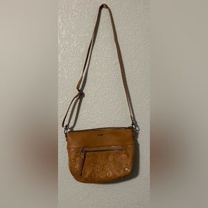 Brown purse with detailing in the front with brown wallet that matches